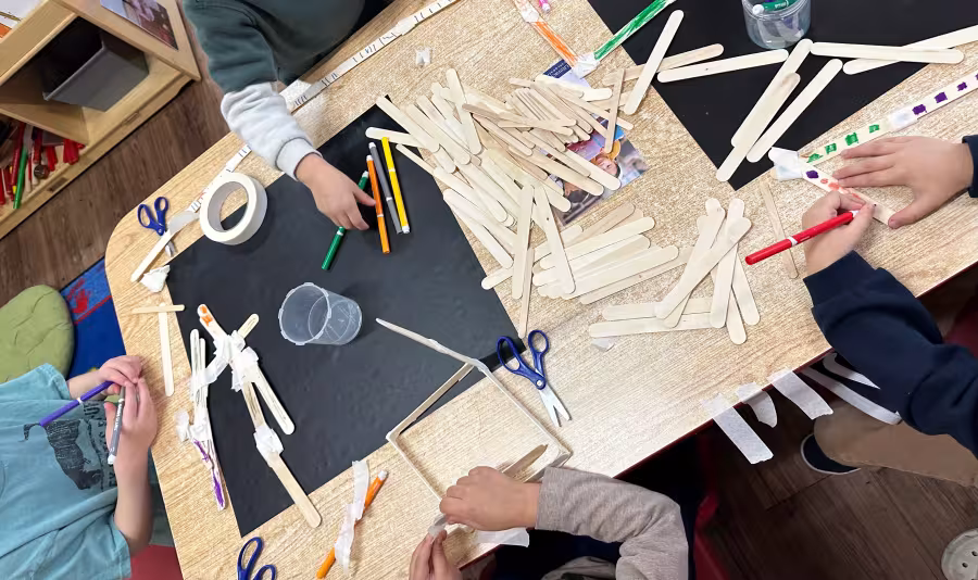 Students around a table of tongue depressors