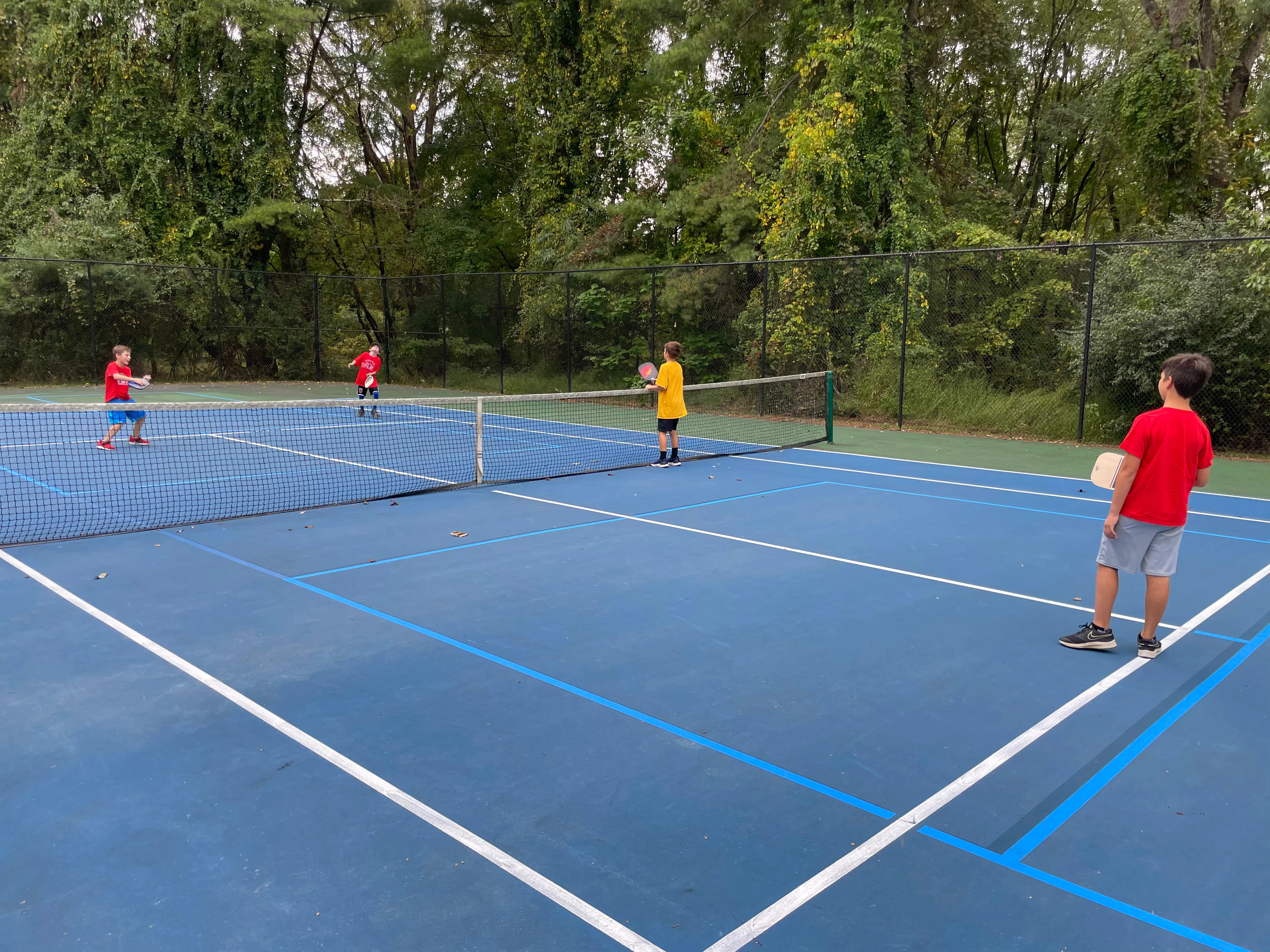 Elementary students playing pickleball